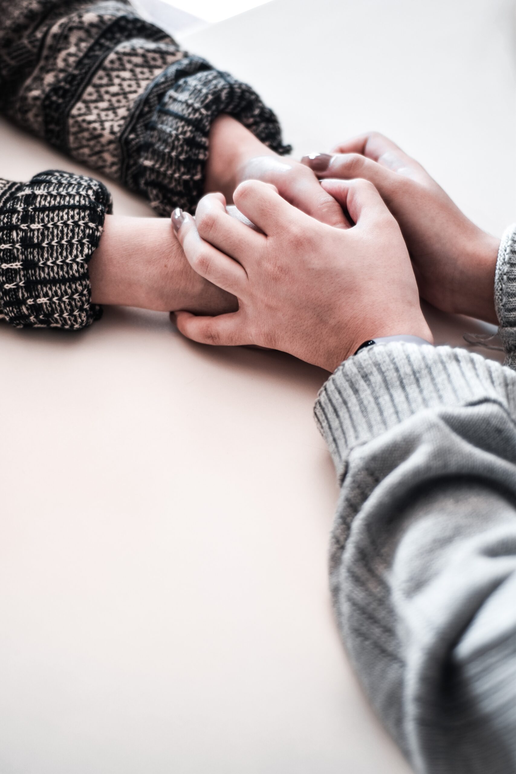 parent holding hands of a child in support